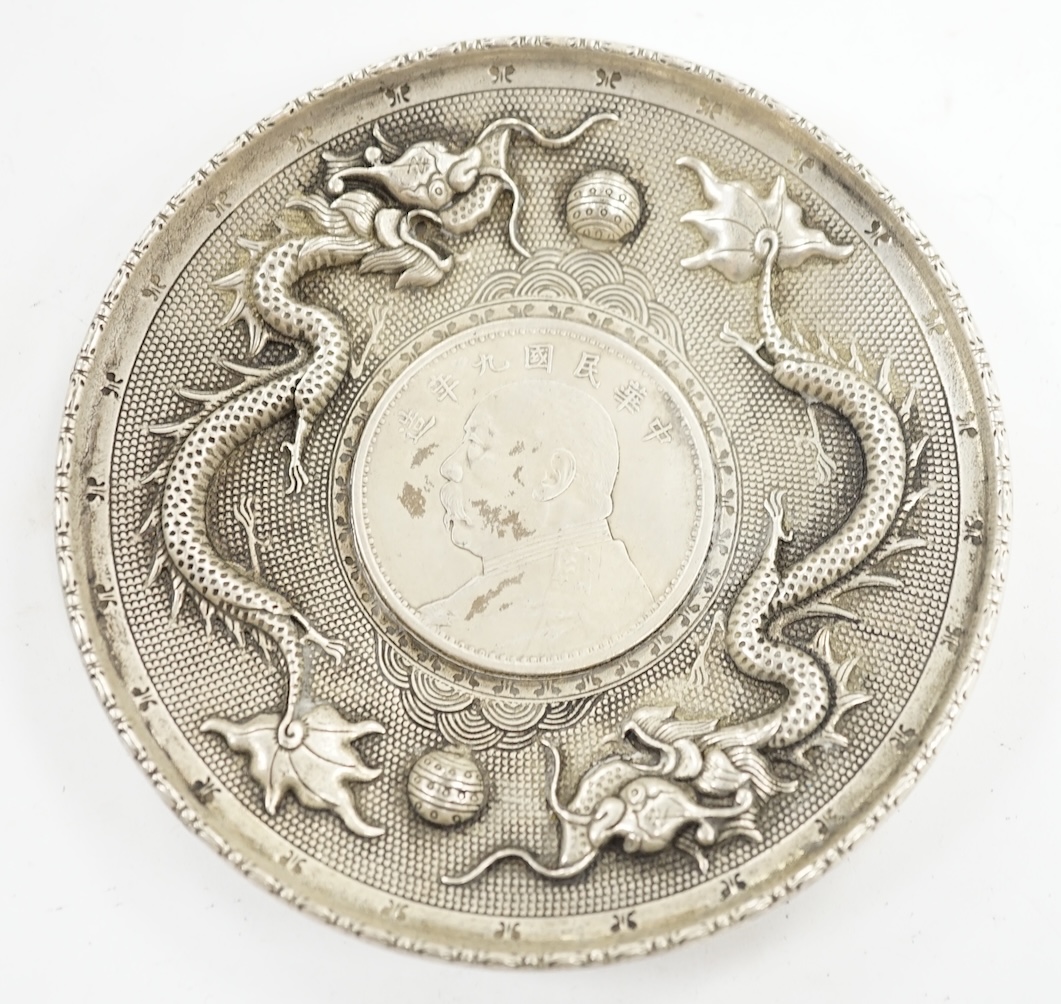 A Chinese white metal dish inset with Yuan Shikai coin, 10.1cm. Condition - fair